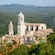 Verdant mountains surround a medieval town with a cathedral
